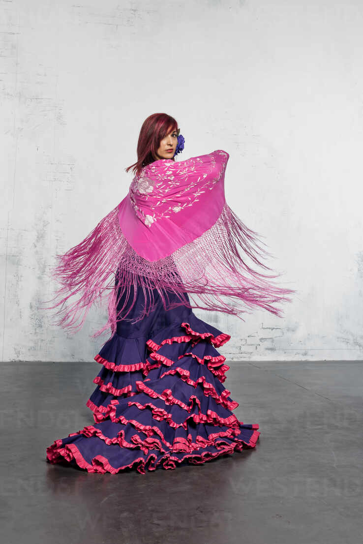 Flamenco dancer in action with the typical Spanish dance costume. High  speed and movement. stock photo