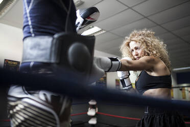 Adult woman in boxing gloves fighting with partner - ADSF05304