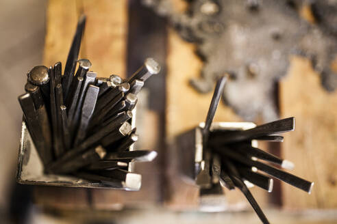 Crop view of hammer and instruments on wooden metallurgical table - ADSF05456