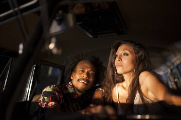 Beautiful and young brunette girl enjoys the trip in her vintage van with some friends - ADSF05470