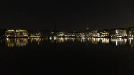 Hamburg cityscape illuminated in Elbe River at night, Germany - FSIF04884