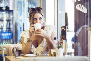 Attraktive Frau hält weiße Tasse in der Hand - ADSF05474