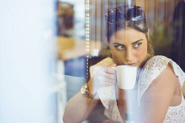 Attractive female holding white cup in hand - ADSF05478