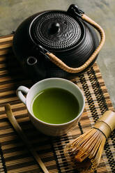 Preparing matcha tea with bamboo whisk - ADSF05616