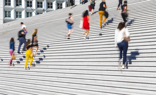 Business people climbing staircase during rush hour, Paris, France - HSIF00786