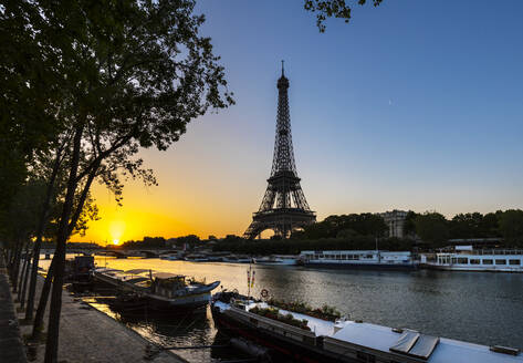 Eiffel Tower by Seine river against clear blue sky during sunrise, Paris, France - HSIF00792