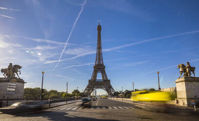 Road leading to Eiffel Tower against cloudy sky, Paris, France - HSIF00800