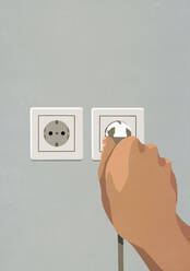 Hand plugging cord into electrical outlet - FSIF05017
