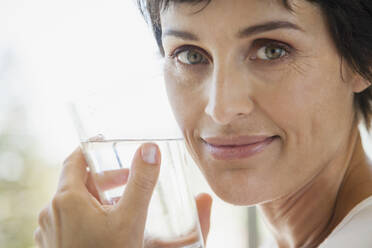 Close up portrait woman drinking water - FSIF05056