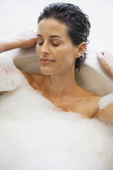 Serene woman enjoying bubble bath - FSIF05130