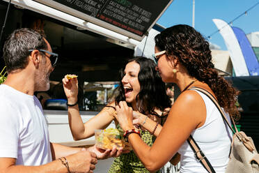 People eating snacks at food truck - ADSF06053