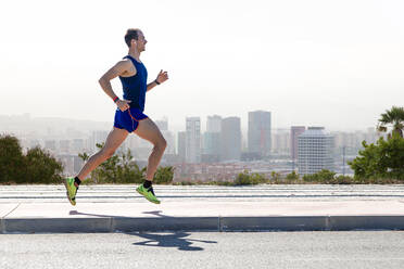 Portrait of handsome young man running in the park. - ADSF06069