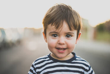 Portrait of lovely little boy with brown eyes and hair looking at camera with smile.Bokeh - ADSF06073