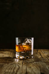 Glass of whiskey on a wooden table - ADSF06100