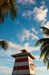 Tropical seashore with small wooden lighthouse on pier with yellow houses in row, Panama - ADSF06123