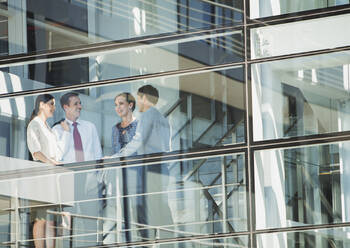 Business people talking at window - CAIF28424