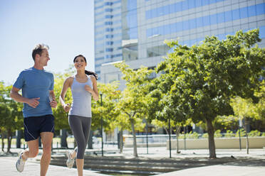 Couple jogging in urban park - CAIF28467