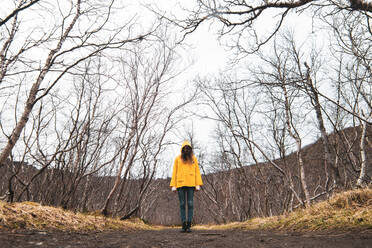 Person standing on countryside road - ADSF06178