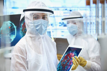 Portrait female scientist in clean suit researching coronavirus - CAIF28732