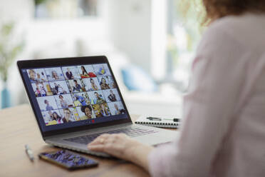 Colleagues video conferencing on laptop screen - CAIF28755