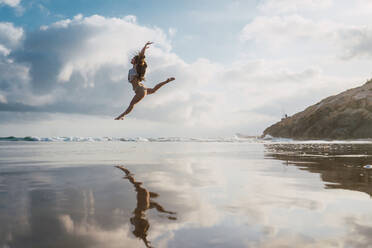 Woman doing exercises on beach - ADSF06279