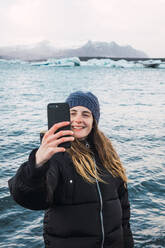 Frau fotografiert am kalten Strand - ADSF06412