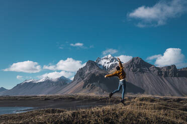 Excited girl jumping on picturesque landscape - ADSF06422