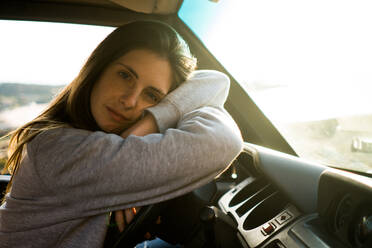 Frau schaut im Auto sitzend in die Kamera - ADSF06501