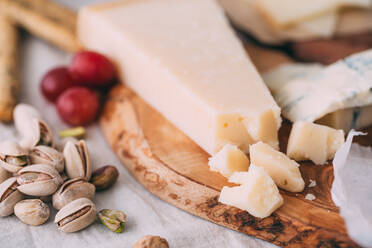 Cheese board with nuts, grapes and bread - ADSF06559