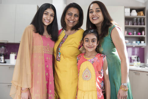 Portrait happy multigenerational Indian women in traditional saris - CAIF28988