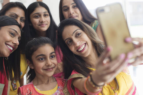 Happy Indian women and girls in saris taking selfie - CAIF29002