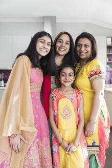 Portrait happy Indian mothers and daughters in saris - CAIF29036