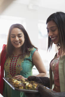 Indian women in saris cooking food - CAIF29063
