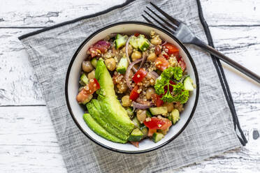 Bowl of vegetarian quinoa salad with chick-peas, avocado, cucumber, tomato, onion and parsley - SARF04604