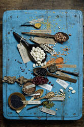 Various beans and lentils on blue rustic wooden surface - ASF06639
