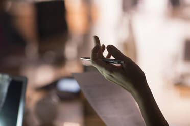 Businesswoman with paperwork gesturing - CAIF29231