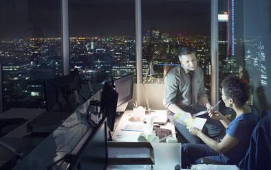 Business people talking in office at night - CAIF29244