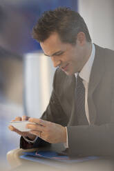Businessman using cell phone - CAIF29328