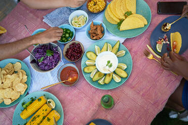 Taco shells and ingredients on patio table - CAIF29366