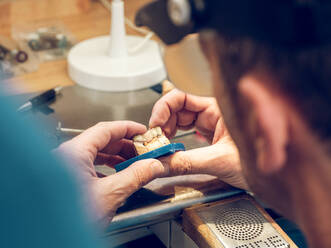 Hands of technician making denture - ADSF07053