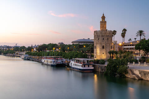 Sunset at Torre del Oro (Tower of Gold), a watchtower on the bank of the Guadalquivir River in Seville, Andalusia, Spain, Europe stock photo