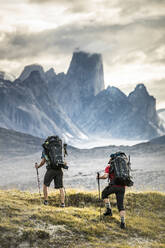 Two climbers hike toward Mount Asgard in Akshayak Pass - CAVF87631