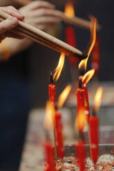 Chinese man burning incense and praying to a prosperous future, Guan Di Chinese Taoist Temple, Kuala Lumpur, Malaysia, Southeast Asia, Asia - RHPLF16546