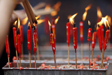 Chinese man burning incense and praying to a prosperous future, Guan Di Chinese Taoist Temple, Kuala Lumpur, Malaysia, Southeast Asia, Asia - RHPLF16548