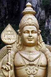 Entrance with the giant statue of Murugan, the Hindu God of War, Hindu Temple and Shrine of Batu Caves, Kuala Lumpur, Malaysia, Southeast Asia, Asia - RHPLF16550