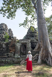 Eine Touristin steht vor den Ruinen des archäologischen Komplexes von Angkor, UNESCO-Weltkulturerbe, Siem Reap, Kambodscha, Indochina, Südostasien, Asien - RHPLF16679