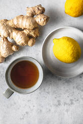 Studio shot of cup of tea, lemons and ginger root - FLMF00270