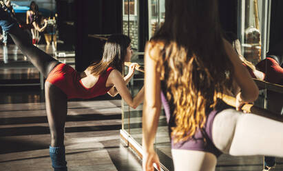 Young fit women training and dancing ballet with barre. - ADSF07185