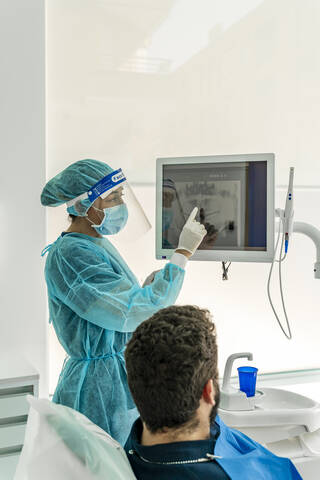 Female nurse talking to patient in dentist's clinic stock photo