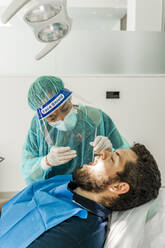 Female nurse examining patient in dentist's clinic - DLTSF00948